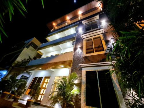 a large building with lights on it at night at Stayinn Nest in Bhopal