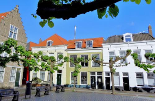 a group of buildings with trees in front of them at B&B Vierwinden in Vlissingen