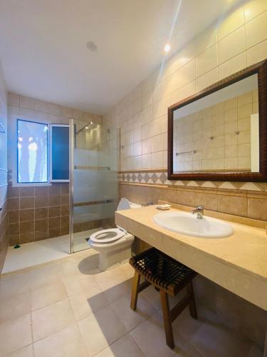a bathroom with a sink and a toilet and a mirror at Sun&Beach 5 in Caleta De Fuste