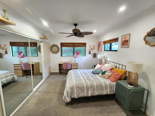 a bedroom with a bed and a ceiling fan at Midnights in Morocco in Brisbane