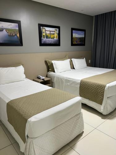 a hotel room with two beds in a room at Dunen Hotel in Piranhas
