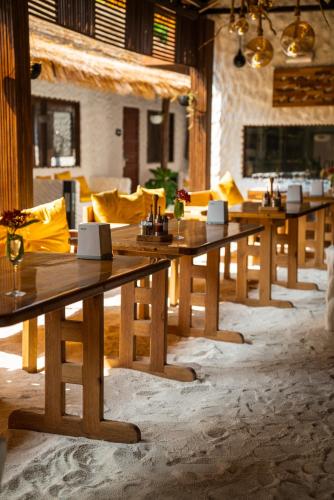 a group of wooden tables in a room with snow at Atholhu Residence in Fehendhoo