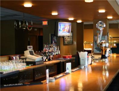 a bar with a counter with glasses on it at Maron Hotel & Suites in Danbury