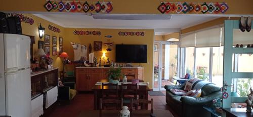 a living room with a couch and a table at A Casa da Ti Laura - AL in Aveiro