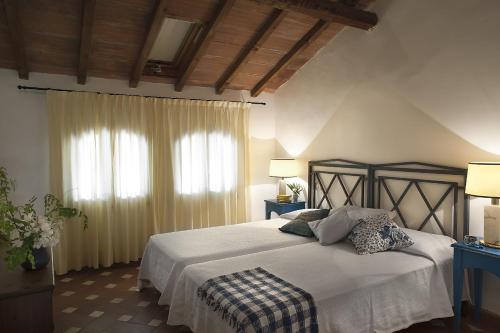 a bedroom with a large bed and a window at Fattoria San Lorenzo in Grosseto