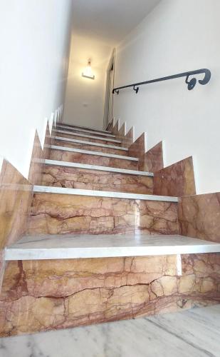 a set of stairs in a building with a bench at GUEST HOUSE PIANA DEGLI ALBANESI in Piana degli Albanesi