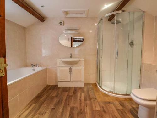 a bathroom with a tub and a sink and a shower at Ty Bont in Wrexham