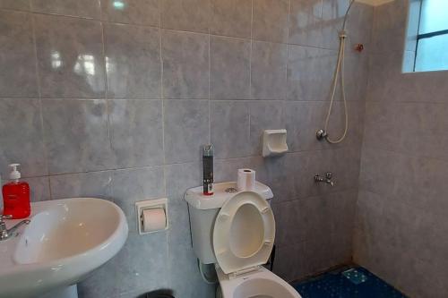a bathroom with a toilet and a sink at 2 bedroom Apt 20 min to JKIA Airport,SGR Train St. in Athi River