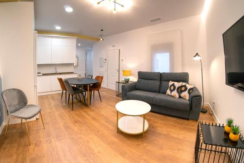 a living room with a couch and a table at Cervantes 5 Collection Catedral - Alcántara in Toledo