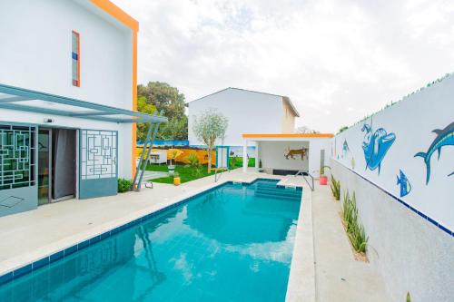 a swimming pool in the backyard of a house at Résidence Decamaret Warang in Ouoran