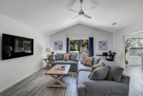 a living room with a couch and a table at PV Clubhouse in Ponte Vedra Beach