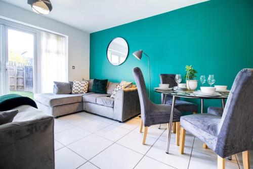 a living room with a couch and a table at 4BR Contractor Town House 2.5bathrooms, 2 free parking spaces managed by Chique Properties in Milton Keynes