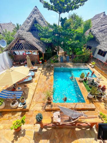 an image of a swimming pool at a resort at Utulivu Bungalow in Nungwi