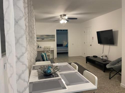 a living room with a table and a tv at Casa del Sol -Unit B in Bayamon
