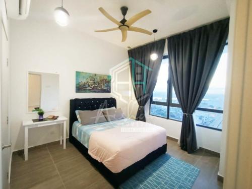 a bedroom with a bed and a ceiling fan at Aishah Homestay L19 Troika Kota Bharu in Kota Bharu