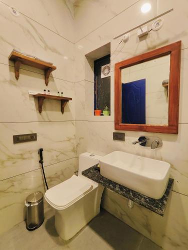 a bathroom with a sink and a toilet and a mirror at The Lanswood Estate in Lansdowne