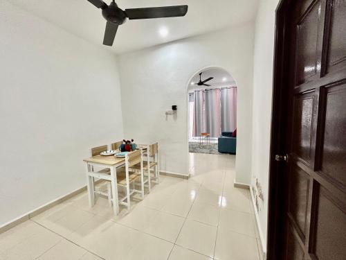 a hallway with a table and a dining room at Cozy 288 Entire 3 bedroom House @ Alma Bukit Mertajam in Bukit Mertajam