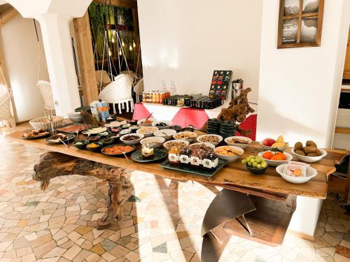 a table with a bunch of food on it at Guesthouse Rosengarten in Dobbiaco