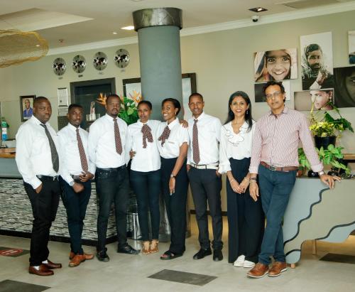 a group of people in ties posing for a picture at Kiriri Garden Hotel in Bujumbura