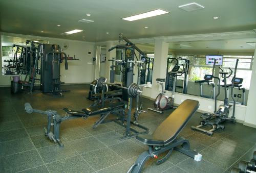 a gym with several exercise equipment in a room at Kiriri Garden Hotel in Bujumbura