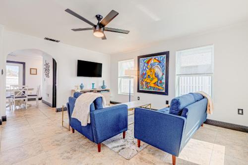 a living room with blue chairs and a ceiling fan at Paradise Dream Vacations #1 in Indialantic