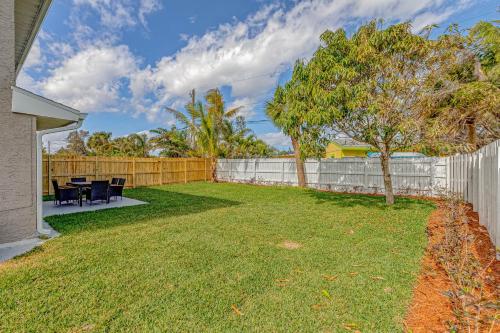 a backyard with a fence and a table and chairs at Paradise Dream Vacations #1 in Indialantic