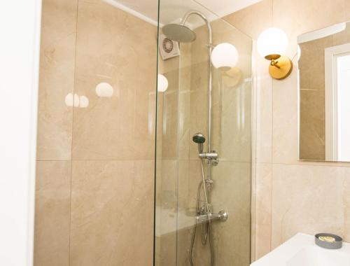 a shower with a glass door in a bathroom at Stamatina's Luxury Apartments (Central 3rd floor) in Alexandroupoli
