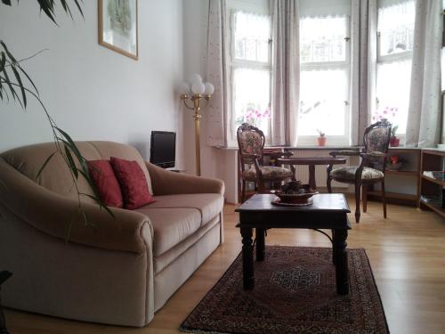 a living room with a couch and a table at Villa Biso in Solingen