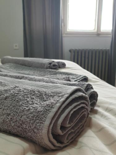 - un ensemble de serviettes assises au-dessus d'un lit dans l'établissement Fenix Apartman, à Zaječar