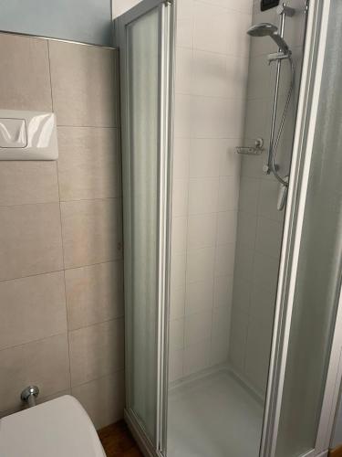 a shower with a glass door in a bathroom at Bramantesco in Bergamo