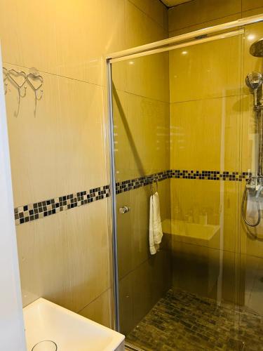 a bathroom with a glass shower and a sink at 36 frere road shelly beach , margate in Margate