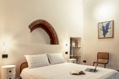 a bedroom with a bed with a book on it at Luxury Loft near Duomo and Garage in Milan