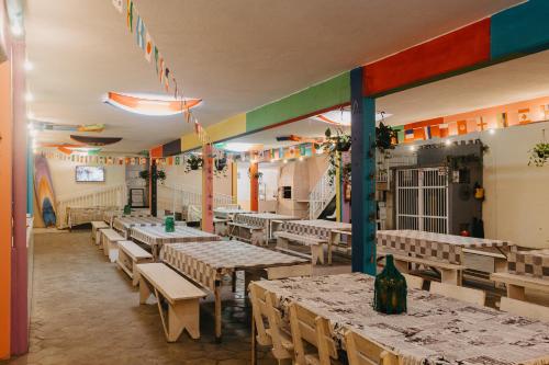 a dining room with tables and chairs and flags at Pousada Sol & Mar in Guaratuba