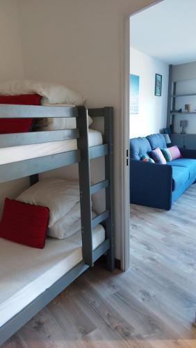 a room with two bunk beds and a couch at Studio Haut De Bordagain Ciboure in Ciboure