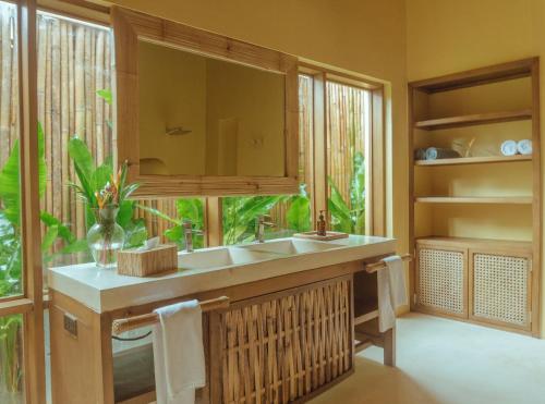 a bathroom with a sink and a large window at INARA Siargao in General Luna