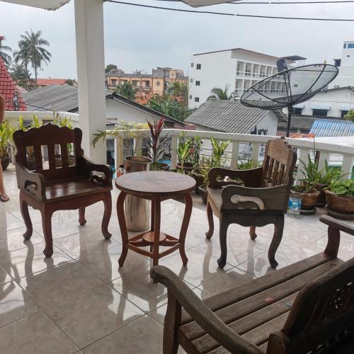 a patio with two chairs and a table and a bench at Haadrin village Fullmoon in Haad Rin