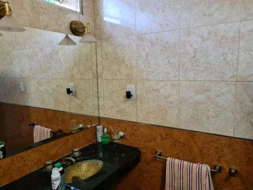 a bathroom with a sink and a large mirror at Casa Al pie del Cerro in Yerba Buena