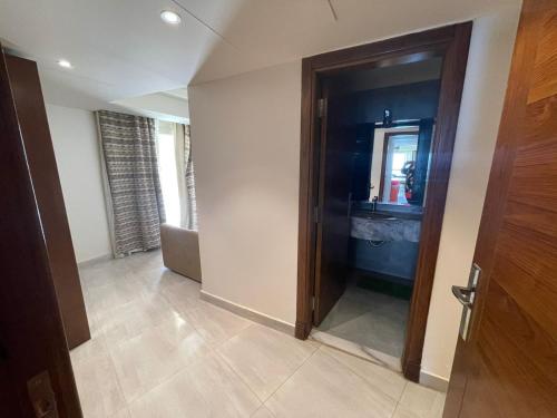 a hallway with a door and a mirror in a room at Amazing sea view Penthouse Apartment in Pyramids Porto El-Sokhna in Ain Sokhna