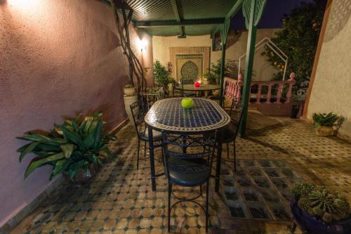 a table with a tennis ball on it on a patio at Riad Raouia HAMMAM & SPA in Fès