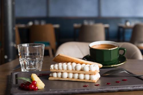 a tray with marshmallows and a cup of coffee on a table at Le Robinet d'Or Paris Canal Saint Martin in Paris