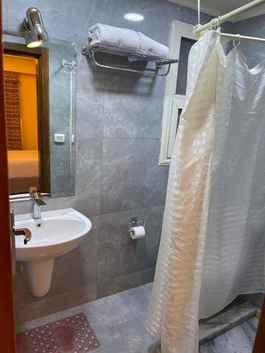a bathroom with a sink and a shower at Amazing sea view Penthouse Apartment in Pyramids Porto El-Sokhna in Ain Sokhna