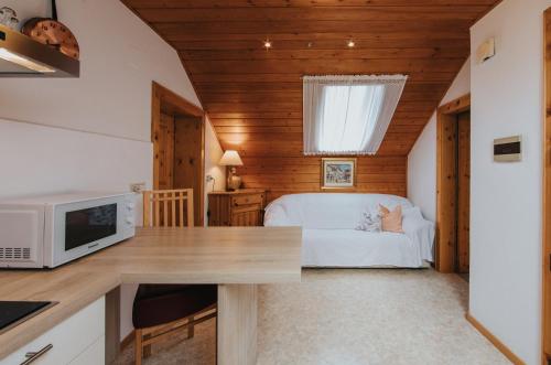 a kitchen with a desk and a bed in a room at Residence Obermoarhof - Family Apartments with Pool & Playground in Vandoies