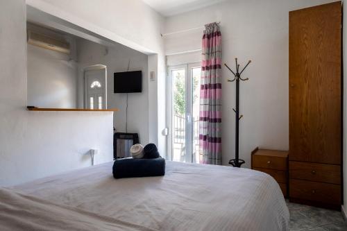 a bedroom with a large bed and a window at Beautiful apartment LA in Larisa