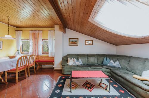 a living room with a couch and a table at Residence Obermoarhof - Family Apartments with Pool & Playground in Vandoies