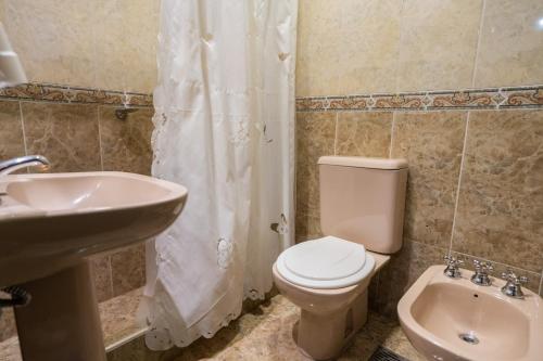 a bathroom with a toilet and a sink at Hotel Marilian in Salta