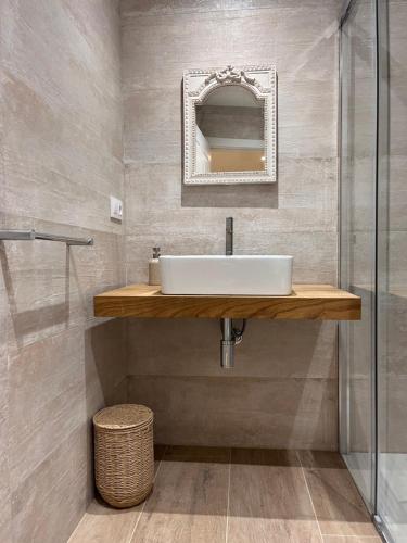a bathroom with a sink and a mirror at Caraxolas in Lugo
