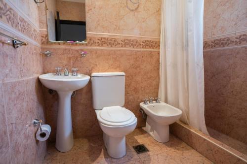 a bathroom with a toilet and a sink at Hotel Marilian in Salta
