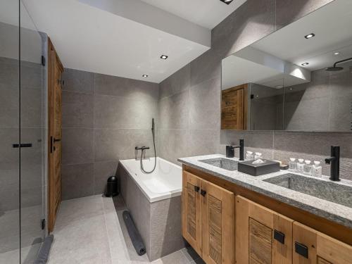 a bathroom with a tub and a sink and a shower at Chalet Courchevel 1550, 7 pièces, 14 personnes - FR-1-562-47 in Courchevel