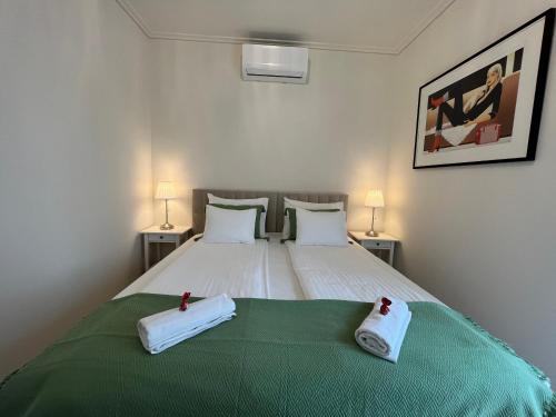 a bedroom with a bed with two towels on it at Nature in the City upper storey Bestern in Szeged