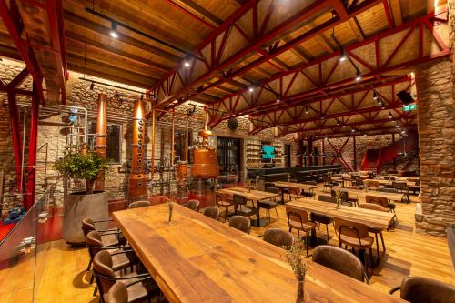 a large room with wooden tables and chairs at Melesin Distillery in Leskovik